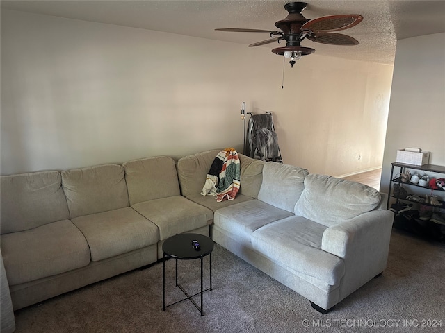 living room with carpet flooring, a textured ceiling, and ceiling fan