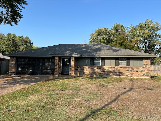 ranch-style home with a front yard and a garage