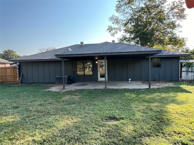 back of house featuring central AC, a yard, and a patio area