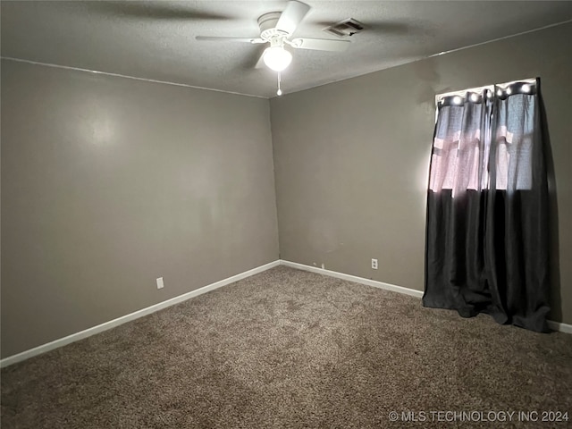 spare room with a textured ceiling, ceiling fan, and carpet flooring