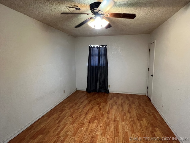 unfurnished room with hardwood / wood-style flooring, a textured ceiling, and ceiling fan