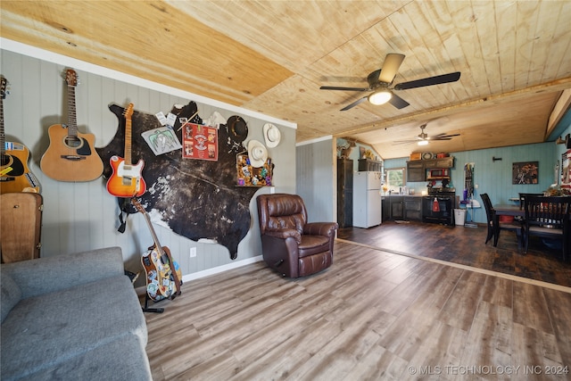 living room featuring wood-type flooring, ceiling fan, wood walls, and wood ceiling