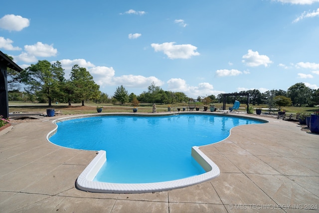 view of swimming pool featuring a patio area