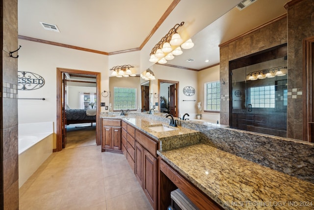 bathroom featuring independent shower and bath, tile patterned flooring, vanity, and a healthy amount of sunlight