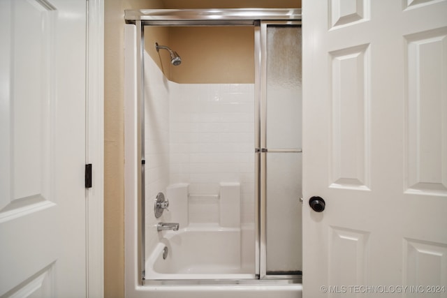 bathroom featuring bath / shower combo with glass door