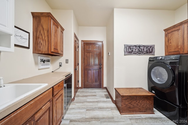 washroom with washer / dryer, wine cooler, sink, and cabinets