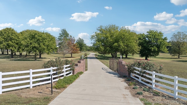 surrounding community with a rural view and a lawn