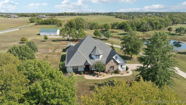 drone / aerial view featuring a water view and a rural view