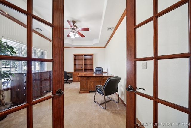 carpeted office with a towering ceiling, ceiling fan, french doors, and a raised ceiling