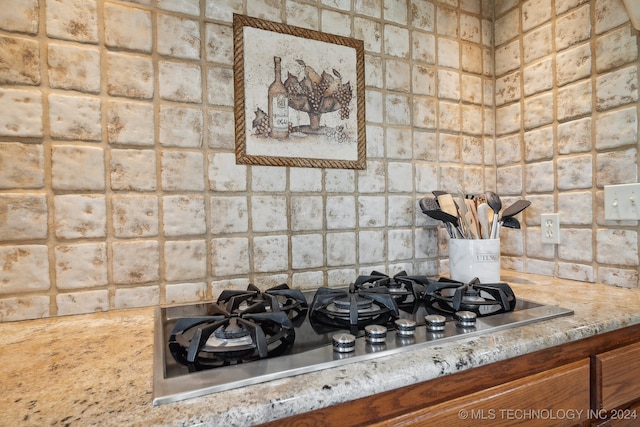 kitchen featuring light stone countertops and stainless steel gas stovetop