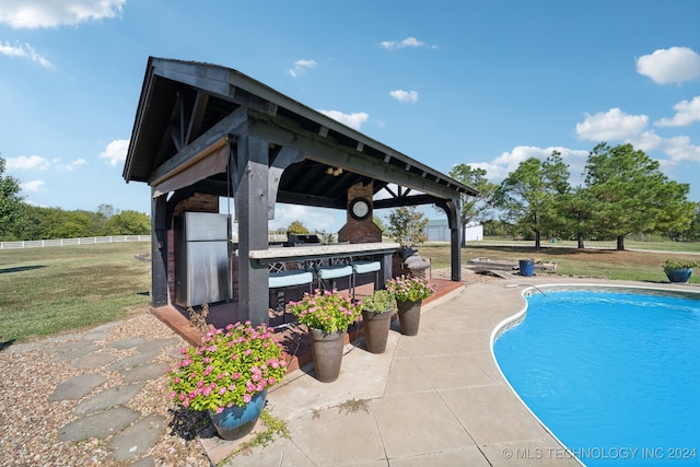 view of pool with a gazebo, a lawn, and a patio