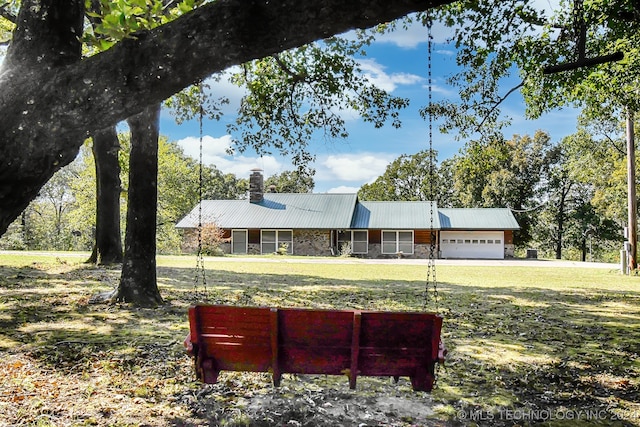 view of front of home featuring a garage and a front lawn