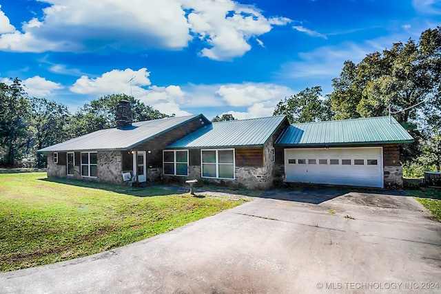 single story home with a garage and a front lawn