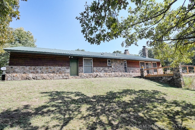 back of house with a yard