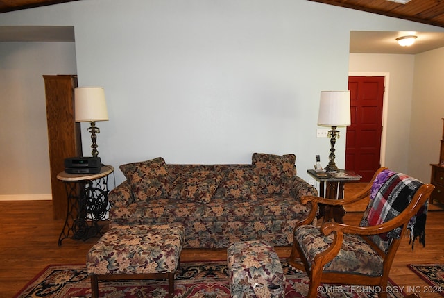 living room with wood-type flooring and vaulted ceiling