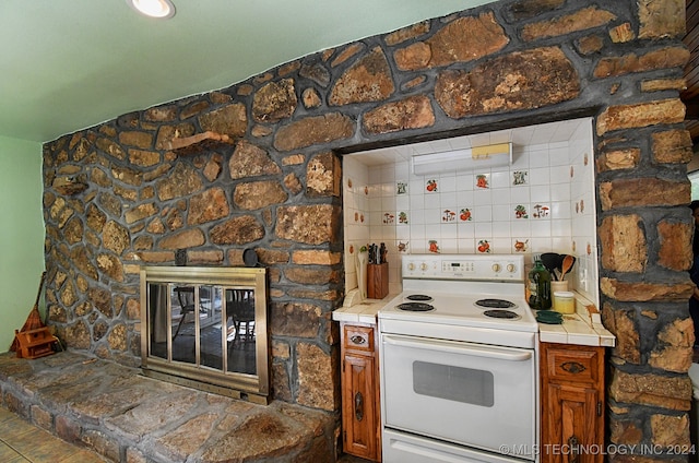 kitchen featuring electric range and tile counters