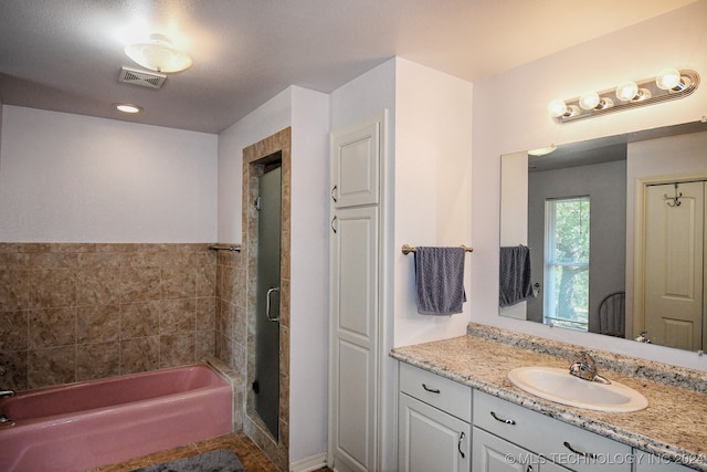 bathroom featuring vanity and plus walk in shower