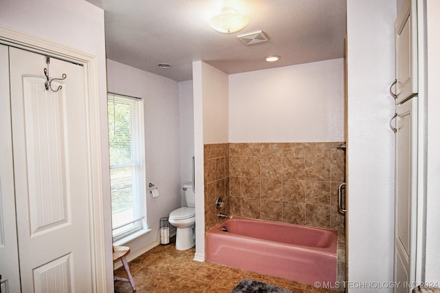 bathroom with separate shower and tub, toilet, and tile patterned floors