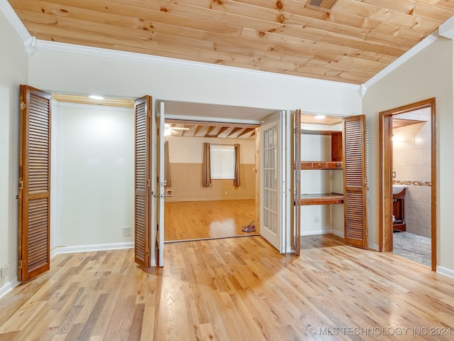 unfurnished bedroom with ornamental molding, ensuite bath, light hardwood / wood-style floors, and wooden ceiling