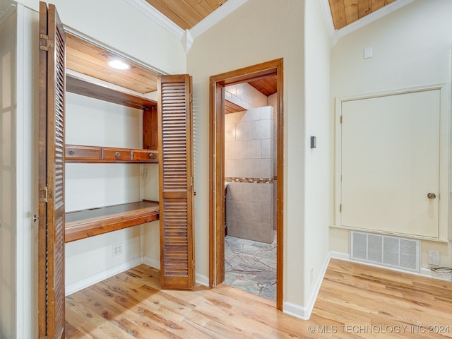 hall featuring crown molding, vaulted ceiling, light hardwood / wood-style floors, and wooden ceiling