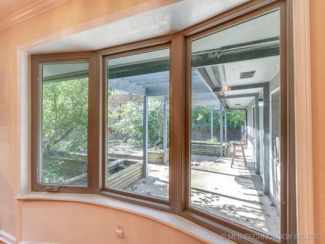 entryway featuring plenty of natural light and ornamental molding