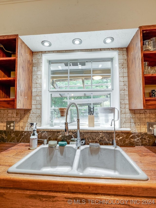 kitchen with plenty of natural light, a sink, and decorative backsplash