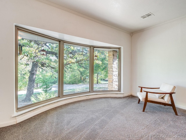empty room with carpet flooring, baseboards, ornamental molding, and visible vents