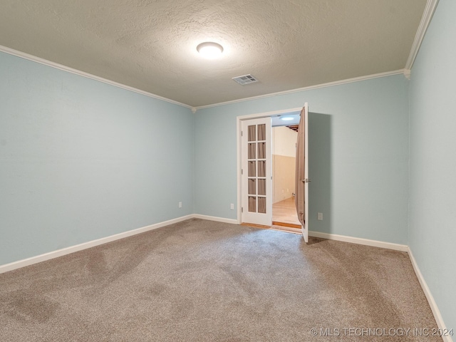 carpeted empty room with baseboards, french doors, a textured ceiling, crown molding, and visible vents