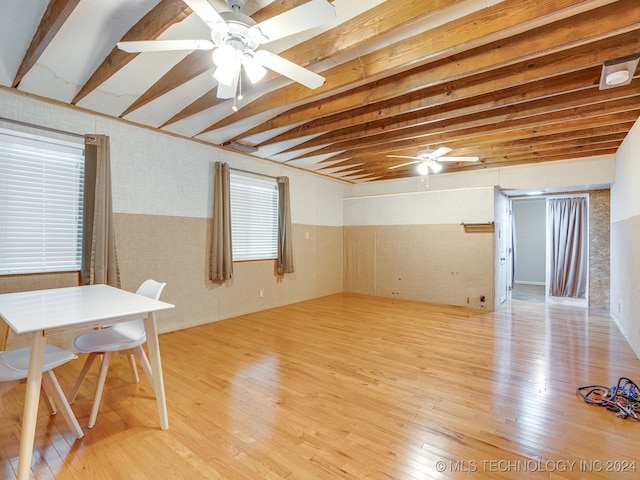 interior space with light hardwood / wood-style floors, beamed ceiling, and ceiling fan