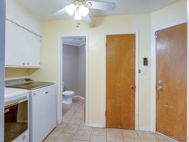 clothes washing area featuring independent washer and dryer, a ceiling fan, light tile patterned flooring, baseboards, and cabinet space