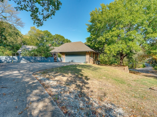 view of front of house with a front yard and a garage