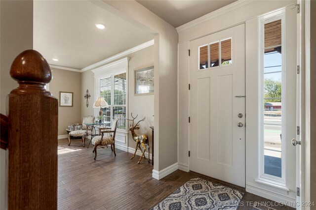 foyer entrance featuring dark hardwood / wood-style floors and crown molding