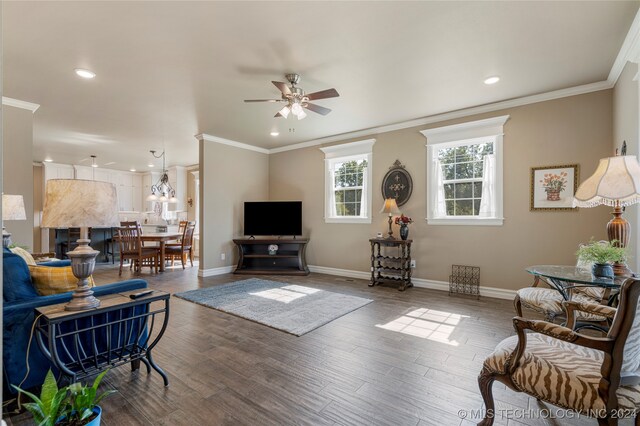 living room with ornamental molding, hardwood / wood-style floors, and ceiling fan