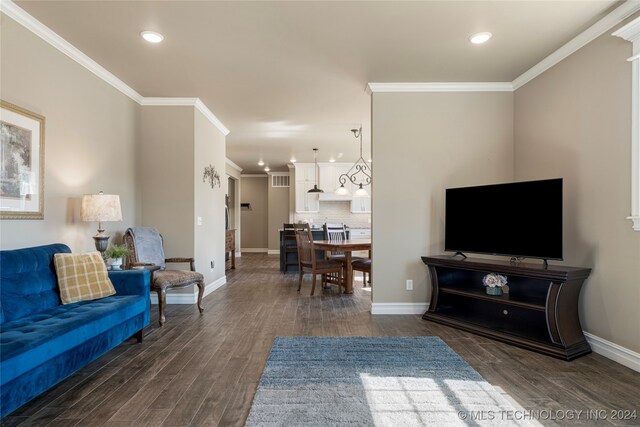 living room with crown molding and dark hardwood / wood-style flooring