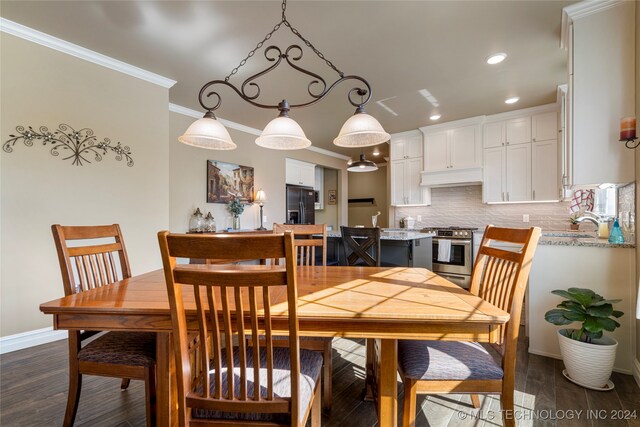 dining area featuring crown molding and dark hardwood / wood-style flooring