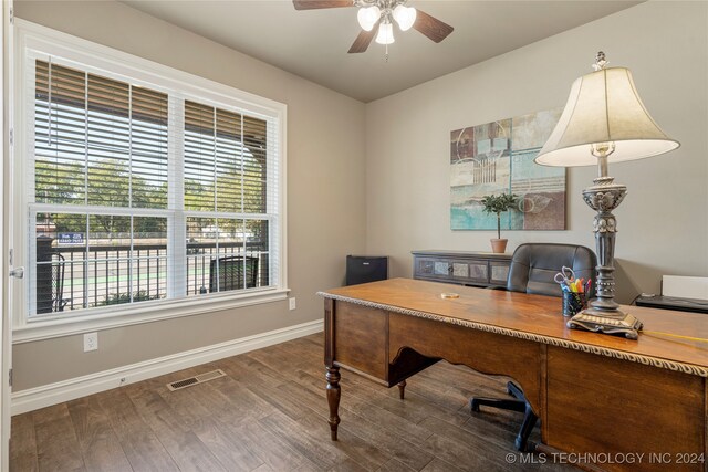 home office featuring ceiling fan and dark hardwood / wood-style flooring