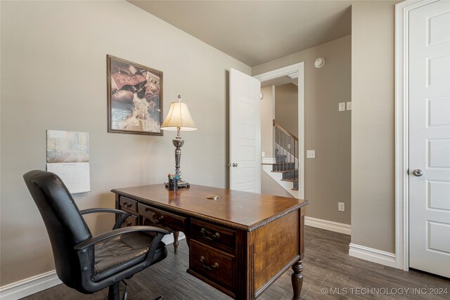 home office with dark hardwood / wood-style floors