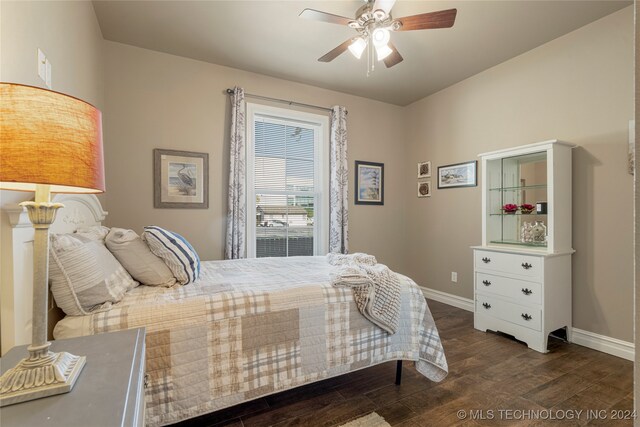 bedroom with ceiling fan and dark wood-type flooring