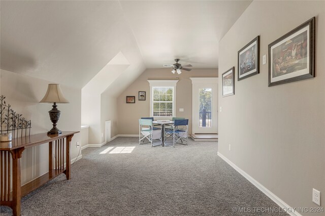 dining room featuring ceiling fan, vaulted ceiling, and carpet flooring