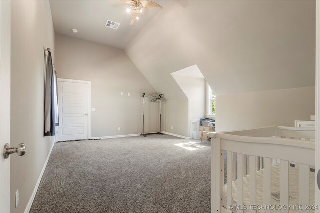 unfurnished bedroom featuring lofted ceiling and carpet floors