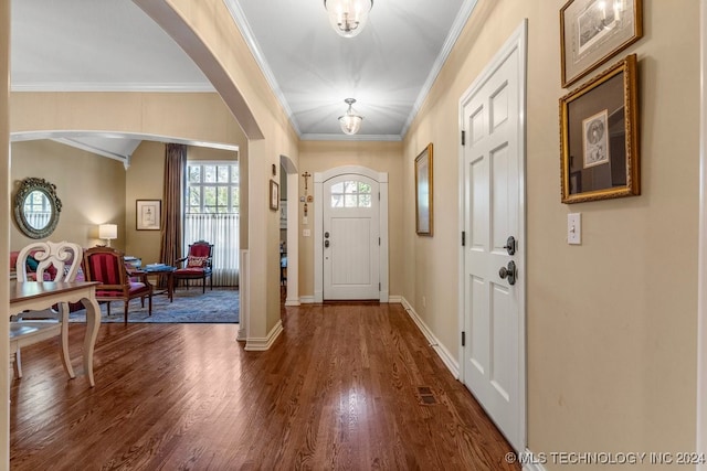 entrance foyer with ornamental molding, decorative columns, and dark hardwood / wood-style floors