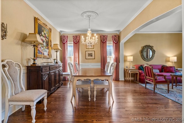 dining space featuring an inviting chandelier, crown molding, and dark hardwood / wood-style flooring