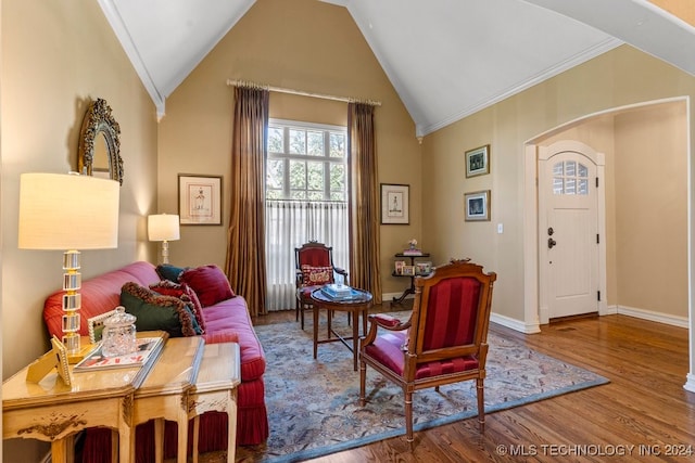 sitting room featuring ornamental molding, lofted ceiling, and wood-type flooring