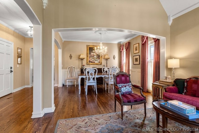 living room with a notable chandelier, crown molding, and dark wood-type flooring