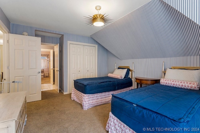 carpeted bedroom with lofted ceiling, a closet, and ceiling fan