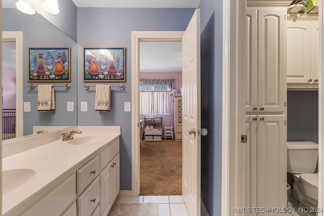 bathroom featuring vanity, toilet, and tile patterned floors