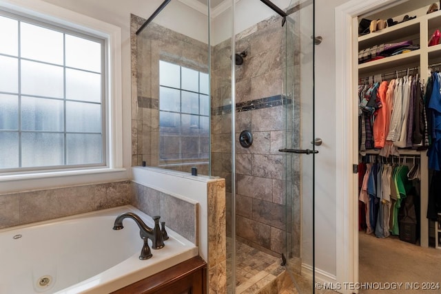 bathroom featuring ornamental molding and shower with separate bathtub