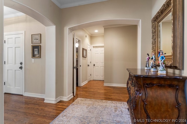 hall with ornamental molding and hardwood / wood-style floors