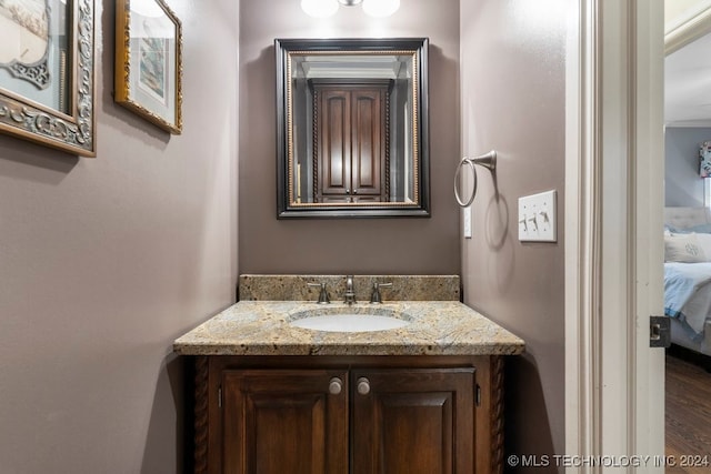 bathroom featuring hardwood / wood-style flooring and vanity