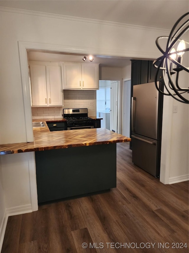 kitchen featuring butcher block countertops, white cabinets, dark wood-type flooring, and appliances with stainless steel finishes